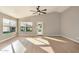 Spacious living room with vaulted ceiling, wood flooring, and access to the backyard at 9829 E Onza Ave, Mesa, AZ 85212