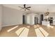 Open living room and kitchen area with wood flooring and lots of natural light at 9829 E Onza Ave, Mesa, AZ 85212