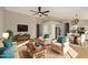 Bright and airy living room with hardwood floors, a ceiling fan, and modern furnishings at 9829 E Onza Ave, Mesa, AZ 85212