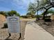 Welcome to Mesquite Canyon with a paved path and playground rules sign in a lush green space at 9829 E Onza Ave, Mesa, AZ 85212
