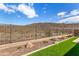 Landscaped backyard with artificial turf and mountain views at 11578 W Montansoro Ln, Peoria, AZ 85383