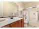 Clean bathroom with single sink, shower/tub combo and linen closet at 11578 W Montansoro Ln, Peoria, AZ 85383