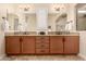 Bright bathroom boasts double vanity with granite countertop and large mirror at 11578 W Montansoro Ln, Peoria, AZ 85383