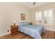 Cozy bedroom with a comfortable bed, wood floors, and plenty of natural light at 11578 W Montansoro Ln, Peoria, AZ 85383