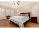 Spacious bedroom with king-size bed and wood floors at 11578 W Montansoro Ln, Peoria, AZ 85383