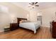 Main bedroom with king bed, ensuite bath access at 11578 W Montansoro Ln, Peoria, AZ 85383