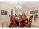 Elegant dining room with chandelier and hardwood floors at 11578 W Montansoro Ln, Peoria, AZ 85383