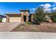 Beautiful desert landscaping surrounds this home with a large driveway at 11578 W Montansoro Ln, Peoria, AZ 85383