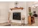 Gas fireplace with decorative mantel and corner shelving at 11578 W Montansoro Ln, Peoria, AZ 85383