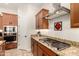 Kitchen with gas cooktop and granite countertops at 11578 W Montansoro Ln, Peoria, AZ 85383