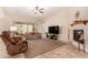 Spacious living room with a fireplace and large windows at 11578 W Montansoro Ln, Peoria, AZ 85383