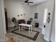 Bright home office with neutral walls, ceiling fan, tile floors, and a white table and black chair at 11578 W Montansoro Ln, Peoria, AZ 85383