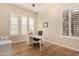Bright home office features a large desk, wood floors, and plenty of natural light at 11578 W Montansoro Ln, Peoria, AZ 85383