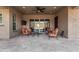 Relaxing covered patio with comfortable seating and ceiling fan at 11578 W Montansoro Ln, Peoria, AZ 85383