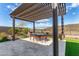 Pergola covered patio with seating for dining and entertaining at 11578 W Montansoro Ln, Peoria, AZ 85383