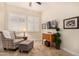 Relaxing sitting area with comfy chair, ottoman, and natural light at 11578 W Montansoro Ln, Peoria, AZ 85383