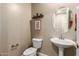 Small half bathroom with pedestal sink and toilet at 1180 E Ridgerock St, Casa Grande, AZ 85122