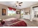 Spacious bedroom with large window, ceiling fan, and plush carpeting at 1180 E Ridgerock St, Casa Grande, AZ 85122