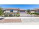Single story home with a two-car garage, and well-manicured lawn at 1180 E Ridgerock St, Casa Grande, AZ 85122