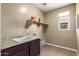 Laundry room with sink, cabinets, and shelving at 1180 E Ridgerock St, Casa Grande, AZ 85122