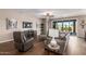 Relaxing living room with hardwood floors and large TV at 1180 E Ridgerock St, Casa Grande, AZ 85122
