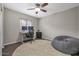 Bright bedroom with wood floors, ceiling fan, and a comfy beanbag chair at 1264 S Cholla St, Gilbert, AZ 85233