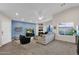 Bright living room with a blue accent wall, comfortable seating, and a large TV at 13246 N 31St Way, Phoenix, AZ 85032