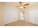 Bedroom with ceiling fan, carpet, and access to another room at 1350 S Greenfield Rd # 2025, Mesa, AZ 85206