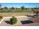 View of backyard with a tree and golf course in the background at 15013 N Cameo Dr, Sun City, AZ 85351