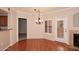 Hardwood floor dining area with chandelier and access to kitchen and patio at 15095 N Thompson Peak Pkwy # 1041, Scottsdale, AZ 85260