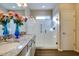 Spa-like bathroom with granite vanity, glass shower, and window at 17103 S 182Nd Ln, Goodyear, AZ 85338