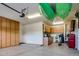 Spacious garage with overhead storage, workbenches, and ample cabinet space at 17103 S 182Nd Ln, Goodyear, AZ 85338