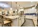 Island kitchen with granite countertops, stainless steel appliances, and hardwood floors at 17103 S 182Nd Ln, Goodyear, AZ 85338