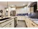 Modern kitchen with granite countertops, stainless steel appliances, and dark backsplash at 17103 S 182Nd Ln, Goodyear, AZ 85338