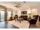 Relaxing living room with leather furniture, large windows, and ceiling fan at 17103 S 182Nd Ln, Goodyear, AZ 85338