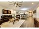 Open concept living room with hardwood floors, comfortable seating and views to the kitchen and dining area at 17103 S 182Nd Ln, Goodyear, AZ 85338