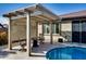 Relaxing pergola with seating area and partial view of the pool at 17103 S 182Nd Ln, Goodyear, AZ 85338