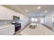 Modern kitchen with white cabinets, stainless steel appliances, and quartz countertops at 1718 W Sombra Ave, Apache Junction, AZ 85120