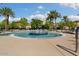 Circular pool with a central fountain and palm trees at 19045 N 269Th Dr, Buckeye, AZ 85396