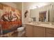 Guest bathroom with toilet, sink, and southwestern-themed decor at 19808 N Shadow Mountain Dr, Surprise, AZ 85374