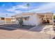 White manufactured home with covered parking and mature landscaping at 201 S Greenfield Rd # 142, Mesa, AZ 85206