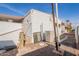 Rear exterior view showcasing the home's siding and AC unit at 201 S Greenfield Rd # 142, Mesa, AZ 85206