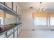 Kitchen boasts white cabinets and a unique mirrored accent wall at 201 S Greenfield Rd # 142, Mesa, AZ 85206