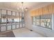 White kitchen cabinets, mirrored backsplash and a chandelier at 201 S Greenfield Rd # 142, Mesa, AZ 85206