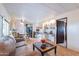 Open living room with a view of the kitchen and a built-in bar at 201 S Greenfield Rd # 142, Mesa, AZ 85206