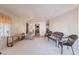 Living room with recliner, wicker chairs and a view into the kitchen at 201 S Greenfield Rd # 142, Mesa, AZ 85206