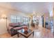 Living area features a brown couch, coffee table, and kitchen access at 201 S Greenfield Rd # 142, Mesa, AZ 85206