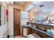 Charming wet bar with sink, shelving, and room for glassware at 201 S Greenfield Rd # 142, Mesa, AZ 85206
