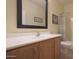 Clean bathroom with wood vanity, large mirror, and shower/tub combo at 22555 W Antelope Trl, Buckeye, AZ 85326