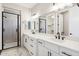 Double vanity bathroom with white cabinets and black matte fixtures at 25893 W Running Deer Trl, Wittmann, AZ 85361